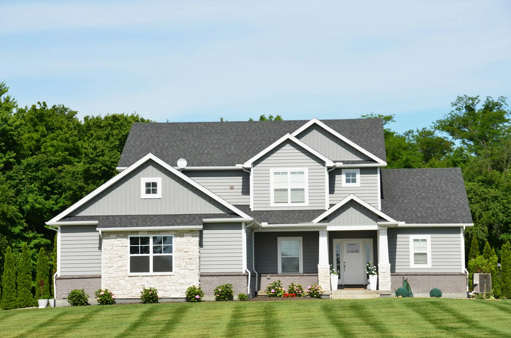 Two-story suburban house with a green lawn